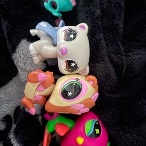 Littlest Pet Shop white ferret armadillo and a neon birdie peacock
